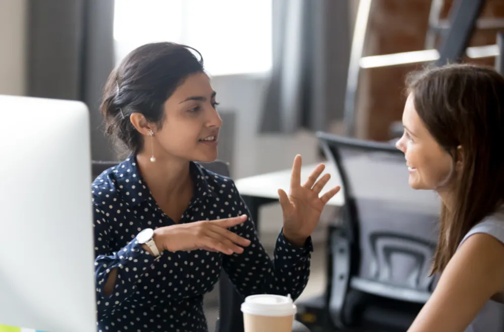 How to become a business coach | Business coach discussing with a client.